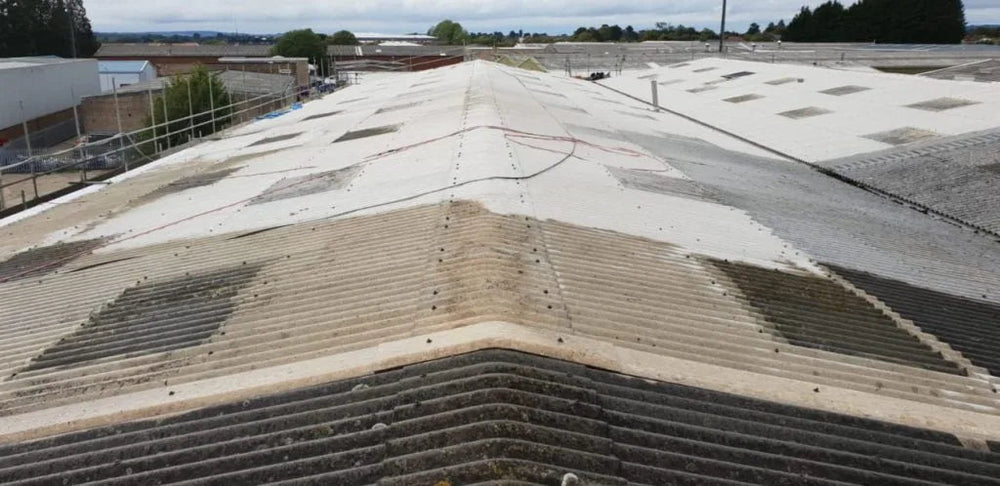 Ageing asbestos-cement industrial roof before a planned refurbishment system